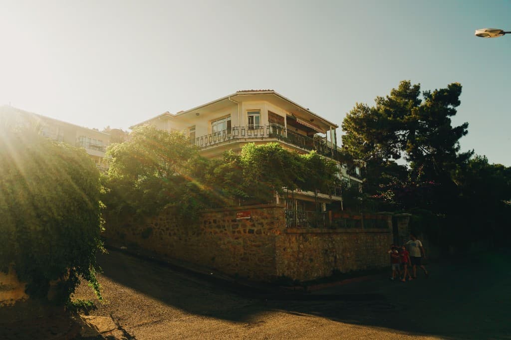 Sunlit residential building on a neighborhood street